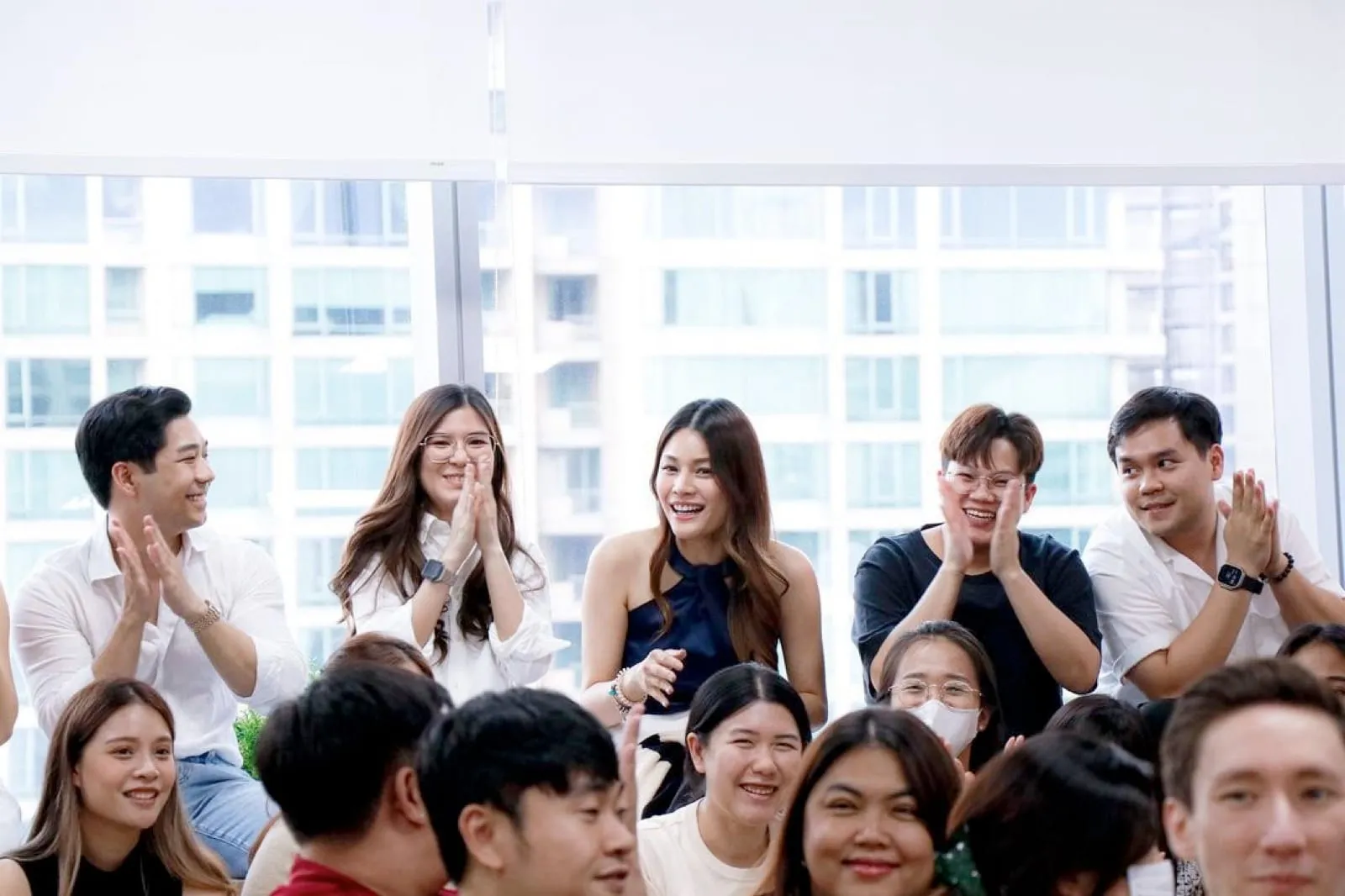The Primal team applauding in the Bangkok office