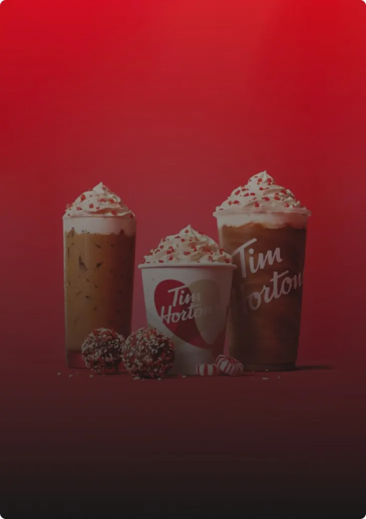 Tim Hortons iced drinks and cups on a red backdrop